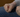 Empty fist rests againt persons leg, wearing jeans