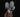 A hand holding three long, phallic looking mushrooms just under their heads