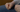 Empty fist rests againt persons leg, wearing jeans
