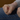 Empty fist rests againt persons leg, wearing jeans