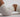 a body in white gym shorts and a gym crop top is arched on the ground