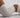 a body in white gym shorts and a gym crop top is arched on the ground