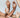 A close up of three pairs of hands, posed expressively among one another.